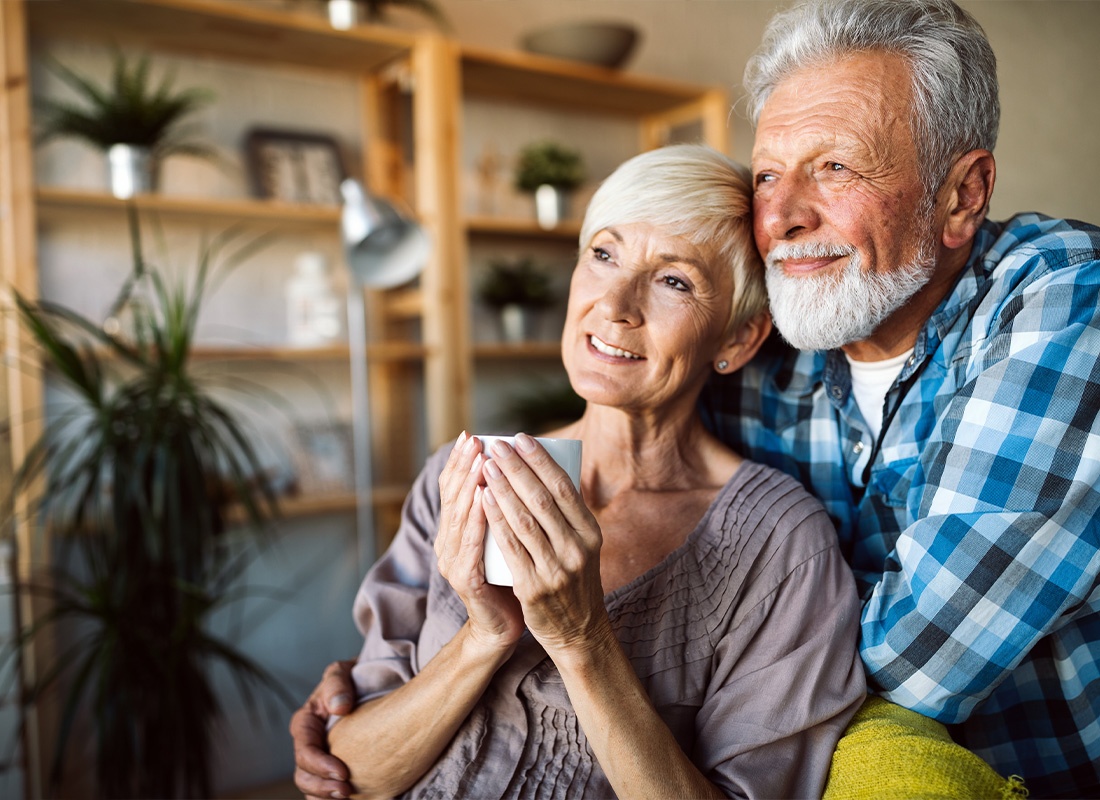 Medicare - Happy Romantic Senior Couple Hugging and Enjoying Retirement at Home